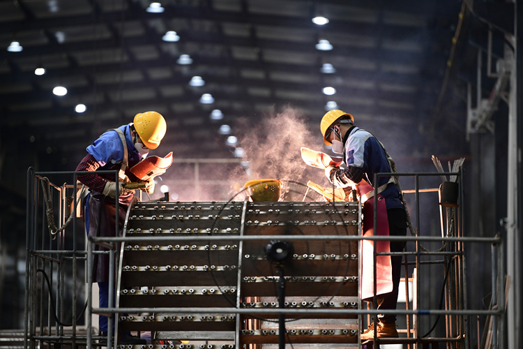 Staff members operate at a workshop in a technology equipment company in Ganzhou, east China's Jiangxi Province, Feb. 13, 2023. (Photo by Hu Jiangtao/Xinhua)