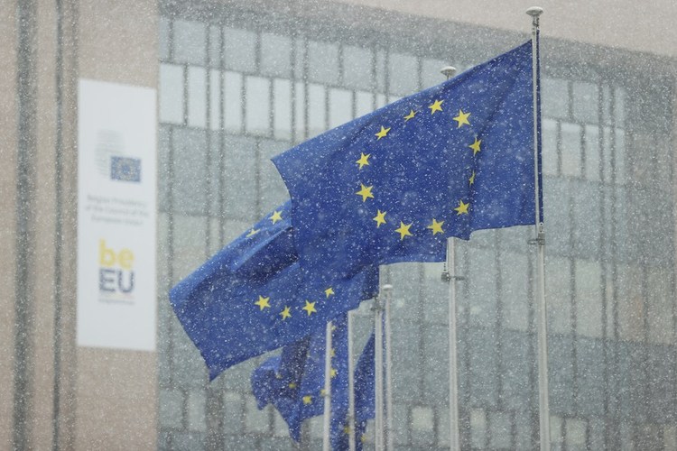 European Union flags are seen in the snow in Brussels, Belgium, Jan. 17, 2024. (Xinhua/Zhao Dingzhe)