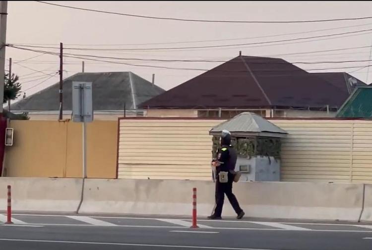 This screenshot captured from a video released on June 23, 2024 shows police patrolling in the street of Russia's Republic of Dagestan.