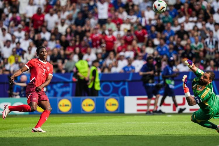 Gianluigi Donnarumma of Italy (R) denies Breel Embolo's shot in their UEFA Euro 2024 last 16 match in Berlin, Germany, June 29, 2024. (Xinhua/Peng Ziyang)