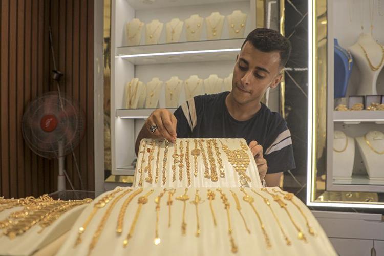 A merchant displays gold jewelry at a gold shop in Khan Younis, southern Gaza, on June 26, 2024. (Photo by Rizek Abdeljawad/Xinhua)