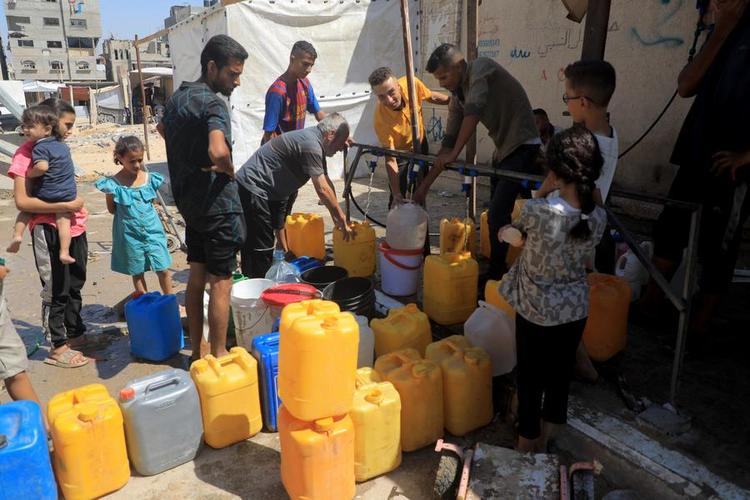 People fetch water in the southern Gaza Strip city of Khan Younis, on July 2, 2024. (Photo by Rizek Abdeljawad/Xinhua)