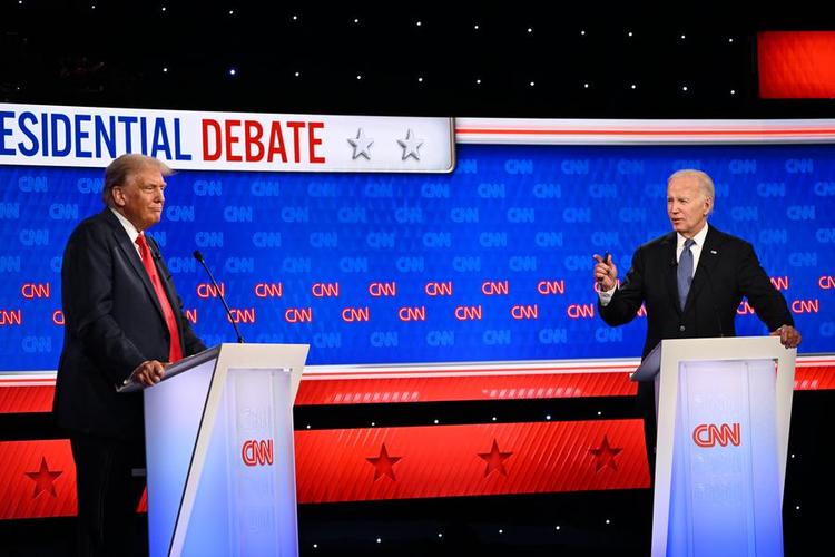 This image provided by CNN shows U.S. President Joe Biden (R) and former President Donald Trump taking the stage at CNN's Atlanta studio for the first presidential debate of the 2024 election on June 27, 2024. (CNN/Handout via Xinhua)