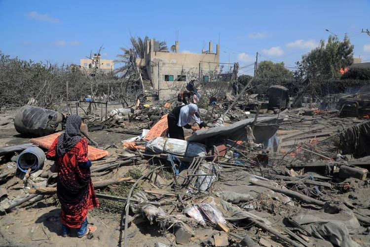 People check the debris after an Israeli airstrike in the Mawasi area of the southern Gaza Strip city of Khan Younis, July 13, 2024. (Photo by Rizek Abdeljawad/Xinhua)