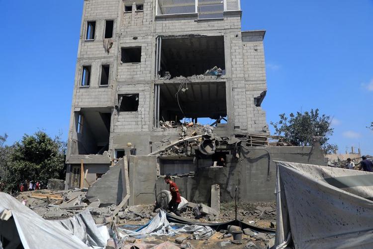 A man checks the debris after an Israeli airstrike in the Mawasi area of the southern Gaza Strip city of Khan Younis, July 13, 2024. (Photo by Rizek Abdeljawad/Xinhua)