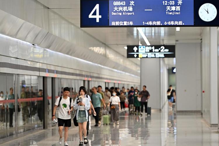 Passengers prepare to board a train bound for north China