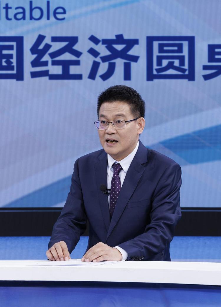 Ding Zhijie, head of the Research Institute at the People's Bank of China, the central bank, speaks at the recording site of the latest episode of the China Economic Roundtable, an all-media talk show hosted by Xinhua News Agency. (Xinhua/Jin Liwang)