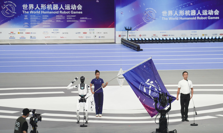A humanoid robot takes an oath during the opening ceremony of the 2025 World Humanoid Robot Games in Beijing, capital of China, Aug. 14, 2025. (Xinhua/Xie Han)