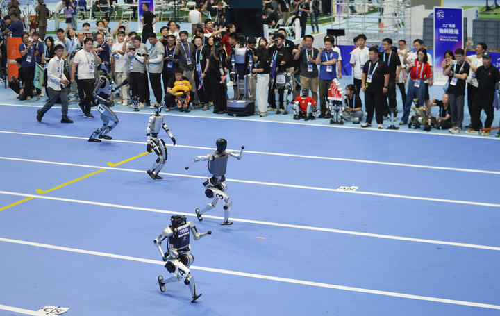 Humanoid robots compete in a 100m race during the opening ceremony of the 2025 World Humanoid Robot Games in Beijing, capital of China, Aug. 14, 2025. (Xinhua/Xie Han)