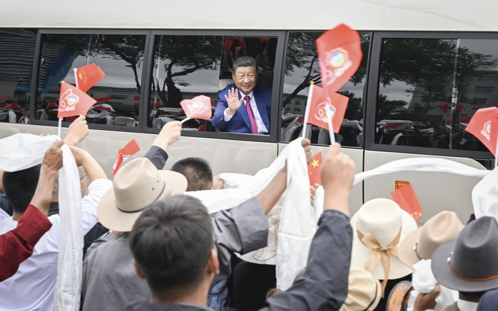 Chinese President Xi Jinping, also general secretary of the Communist Party of China Central Committee and chairman of the Central Military Commission, opens the car window and waves to people in Lhasa, southwest China's Xizang Autonomous Region, Aug. 20, 2025. Xi, who leads a central delegation, arrived in Lhasa, capital of Xizang, on Wednesday to attend activities in celebration of the region's 60th founding anniversary. (Xinhua/Shen Hong)