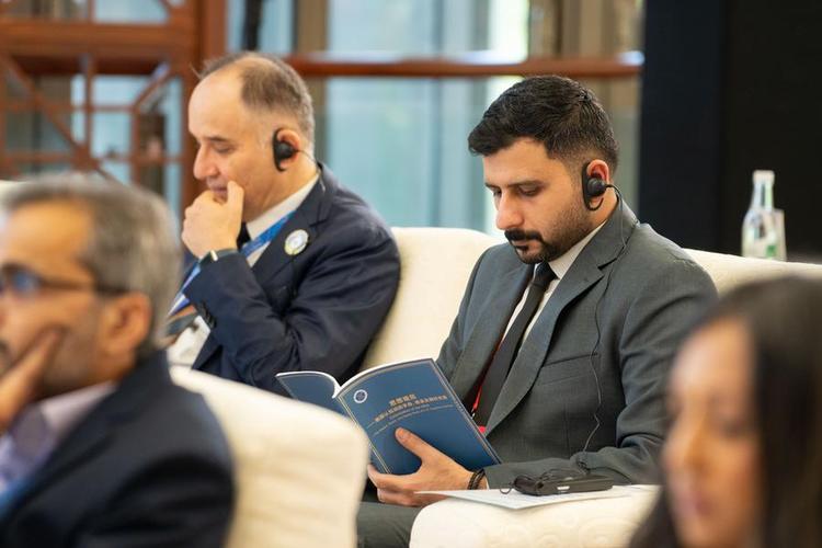 A guest reads a copy of the think tank report "Colonization of the Mind -- The Means, Roots, and Global Perils of U.S. Cognitive Warfare" during the Global South Media and Think Tank Forum 2025 in Kunming, southwest China's Yunnan Province, Sept. 7, 2025. (Xinhua/Gao Yongwei)