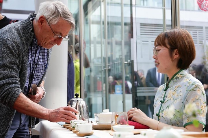 A visitor prepares to taste tea during an opening ceremony of Yaji Cultural Salon "Tea for Harmony" at China Cultural Center in Brussels, Belgium, on May 4, 2023. (Xinhua/Zheng Huansong)