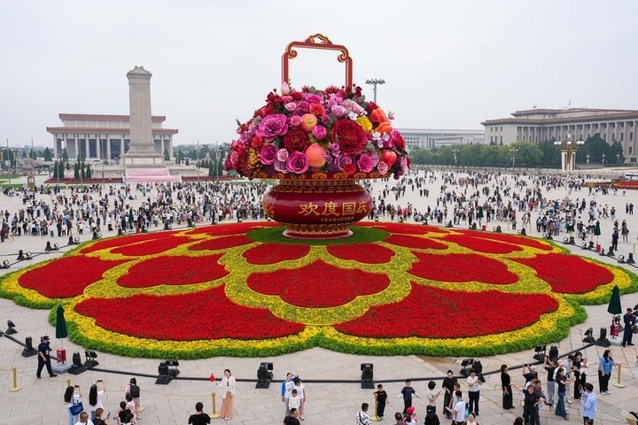 Tourists view a giant floral basket installation at Tian'anmen Square in Beijing, capital of China, Sept. 25, 2026. (Xinhua/Ju Huanzong)