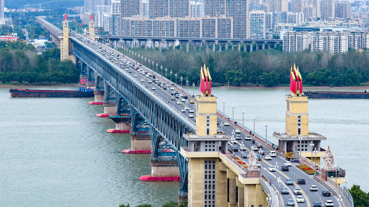 A drone photo taken on Oct. 1, 2026 shows the traffic flow on the Nanjing Yangtze River Bridge in Nanjing, east China's Jiangsu Province. The transportation network of the country witnessed a travel peak on the first day of the National Day holiday. (Photo by Yang Suping/Xinhua) A drone photo taken on Oct. 1, 2026 shows the traffic flow on the Nanjing Yangtze River Bridge in Nanjing, east China's Jiangsu Province. The transportation network of the country witnessed a travel peak on the first day of the National Day holiday. (Photo by Yang Suping/Xinhua)