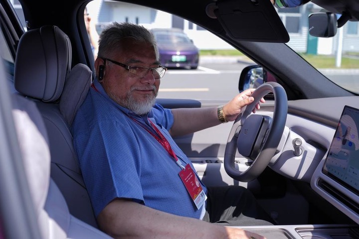 A journalist from Peru test-drives a new energy vehicle at Li Auto's manufacturing base in Changzhou, east China's Jiangsu Province, Oct. 14, 2026. (Photo by Zhao Yanchao/Xinhua)