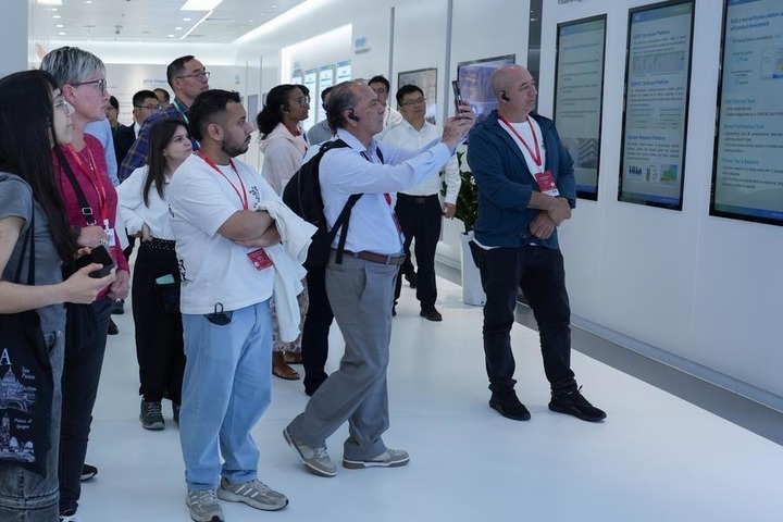 Journalists learn about power transmission technologies while visiting NR Electric in Changzhou, east China's Jiangsu Province, Oct. 14, 2026. (Photo by Zhao Yanchao/Xinhua)